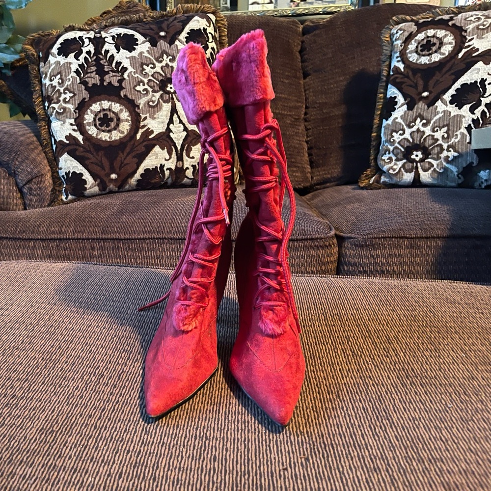 Red knee high suede boots with zipper on side lace up in front and a small heel